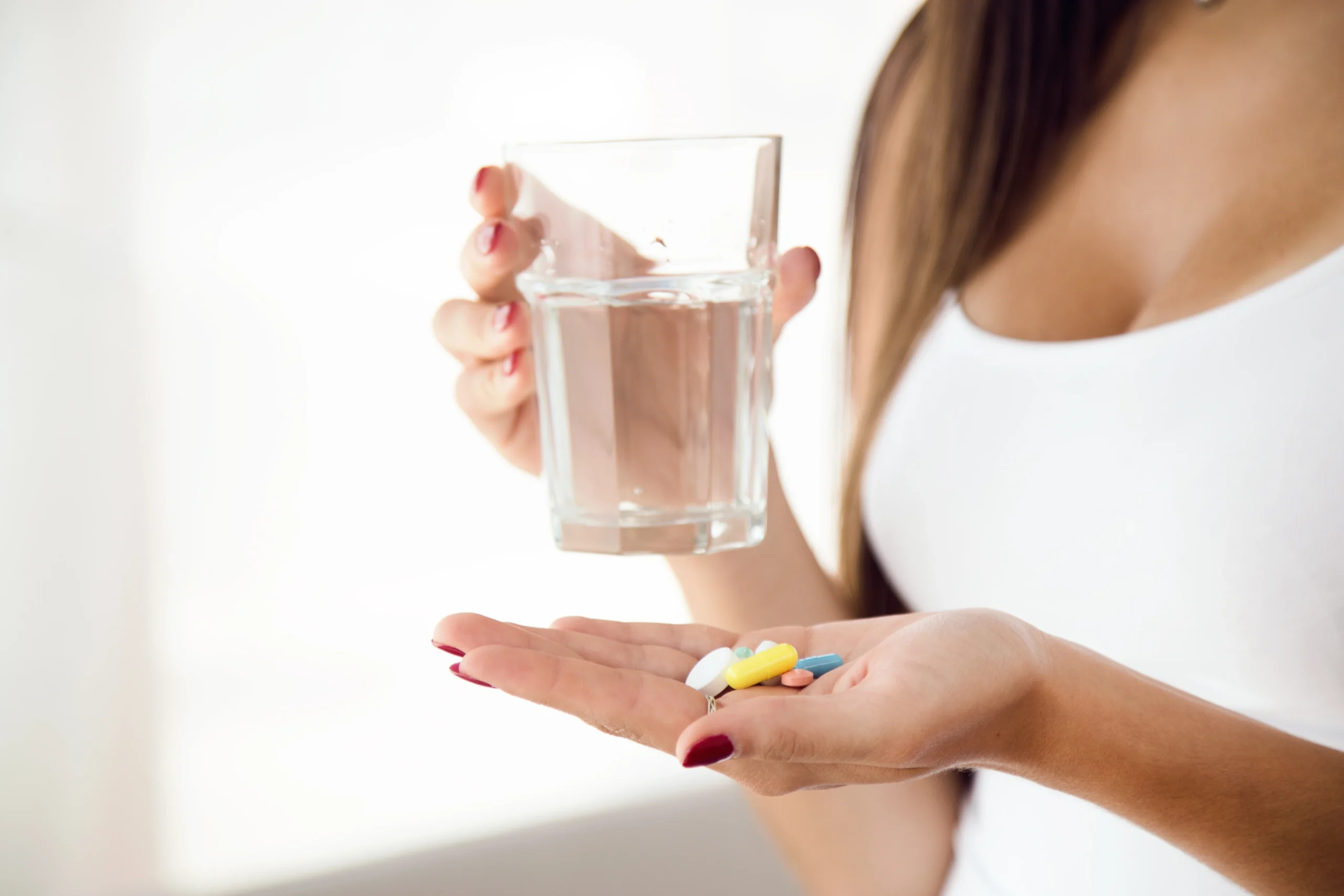 Junge Frau nimmt Tabletten zu Hause als Bild für health product ecommerce trust