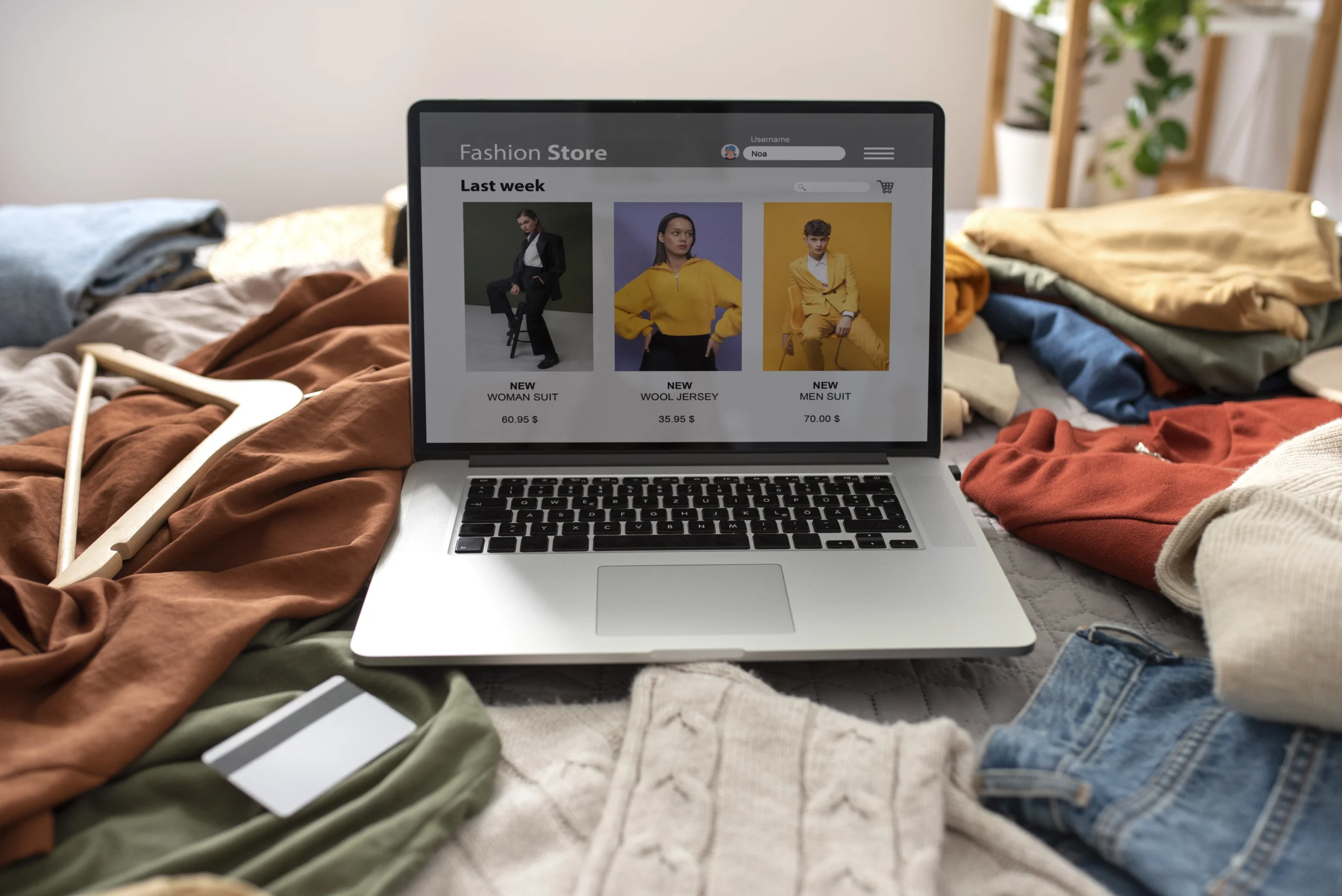 High-angle view of clothes laid out on a bed, fast fashion concept
