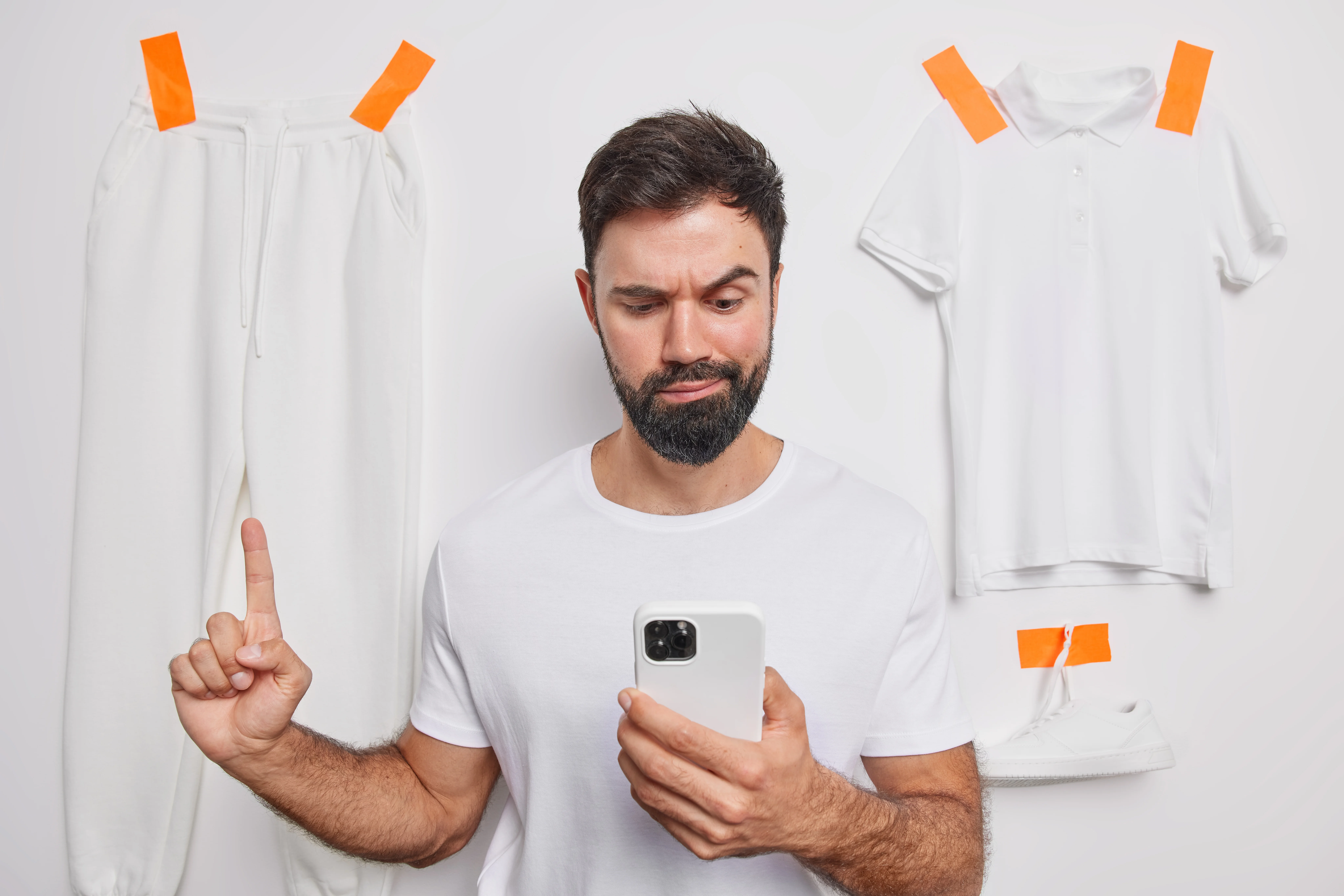Shopper using a mobile phone to buy online, representing a customer captured by a back-in-stock notification on an out of stock page